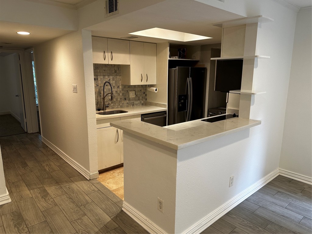 1909 Brun Street, Unit 9 Houston, TX 77019 - Photo 12 of 19 a kitchen with stainless steel appliances granite countertop a refrigerator and a sink