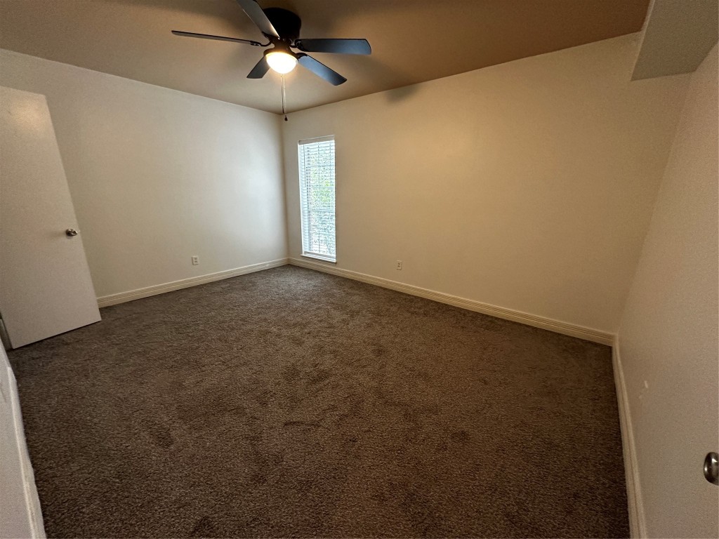 1909 Brun Street, Unit 9 Houston, TX 77019 - Photo 14 of 19 an empty room with a window and ceiling fan