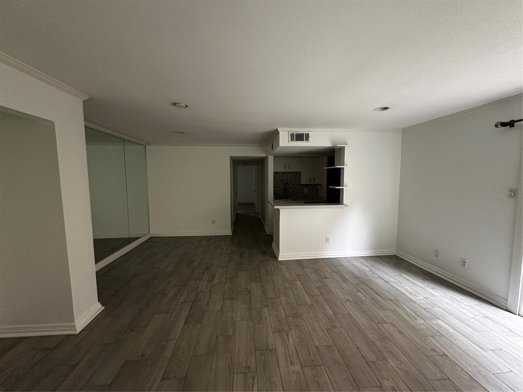 1909 Brun Street, Unit 9 Houston, TX 77019 - Photo 15 of 19 a view of a kitchen with wooden floor and electronic appliances
