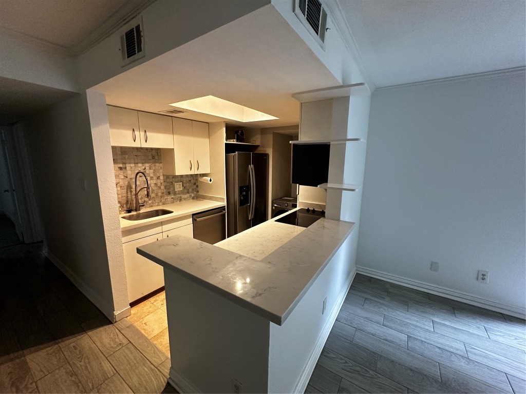 1909 Brun Street, Unit 9 Houston, TX 77019 - Photo 16 of 19 a kitchen with a refrigerator and a sink
