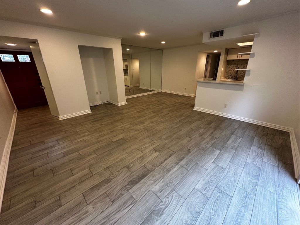 1909 Brun Street, Unit 9 Houston, TX 77019 - Photo 17 of 19 an empty room with wooden floor and windows