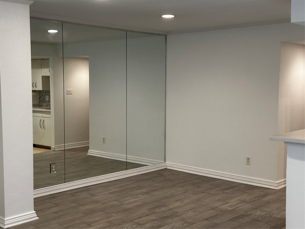 1909 Brun Street, Unit 9 Houston, TX 77019 - Photo 18 of 19 an empty room with wooden floor and windows