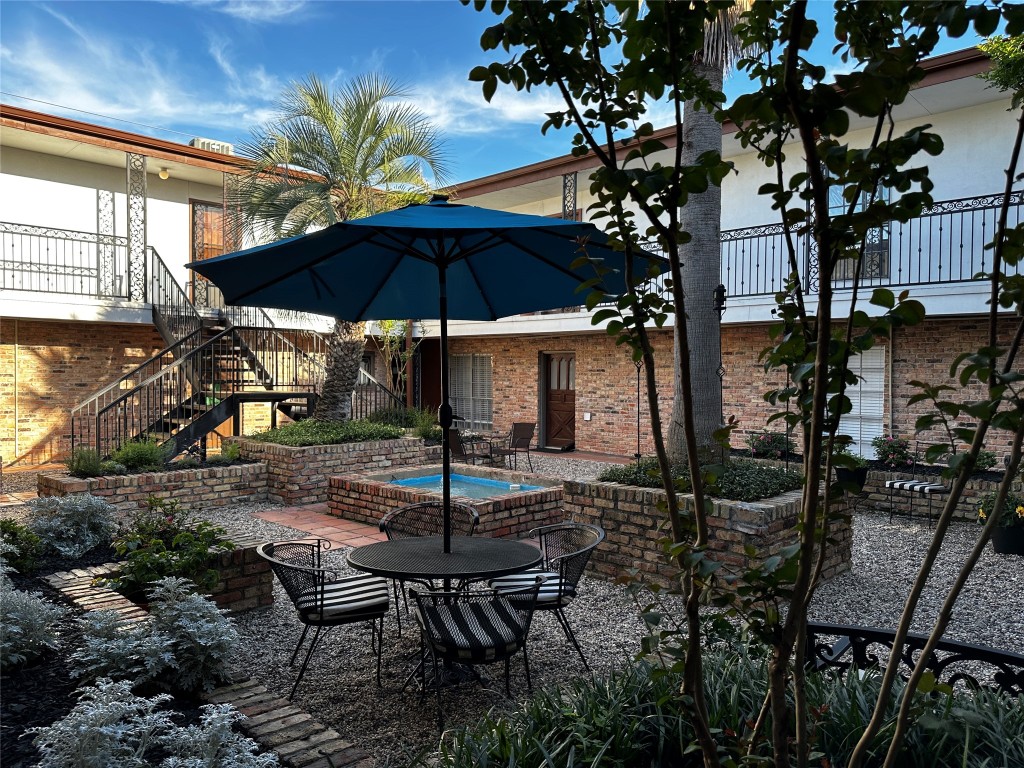 1909 Brun Street, Unit 9 Houston, TX 77019 - Photo 6 of 19 a patio with a patio table and chairs