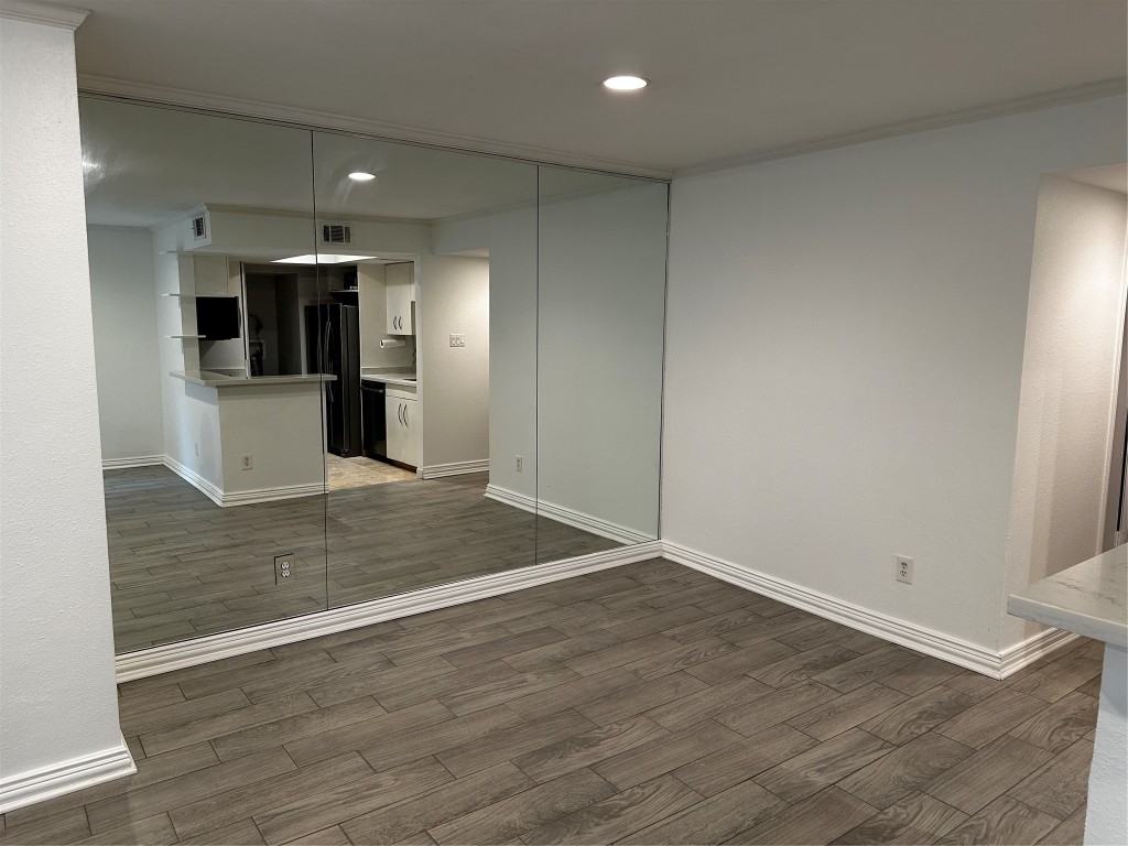 1909 Brun Street, Unit 9 Houston, TX 77019 - Photo 9 of 19 an empty room with wooden floor and appliances