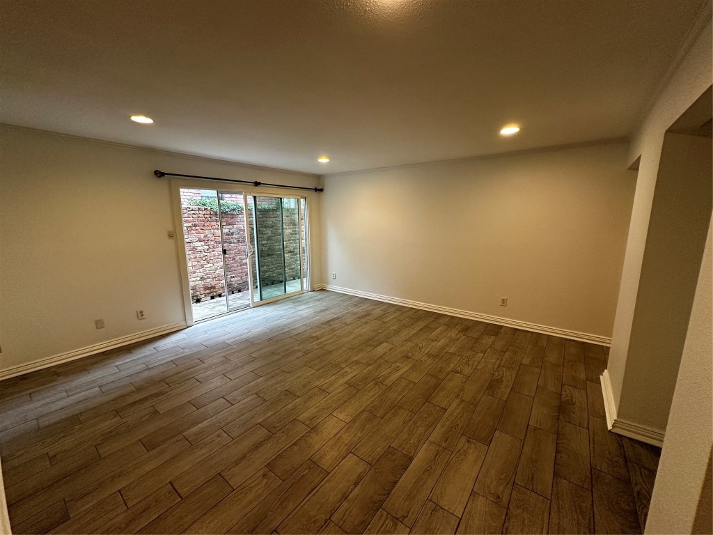 1909 Brun Street, Unit 9 Houston, TX 77019 - Photo 10 of 19 an empty room with wooden floor and windows