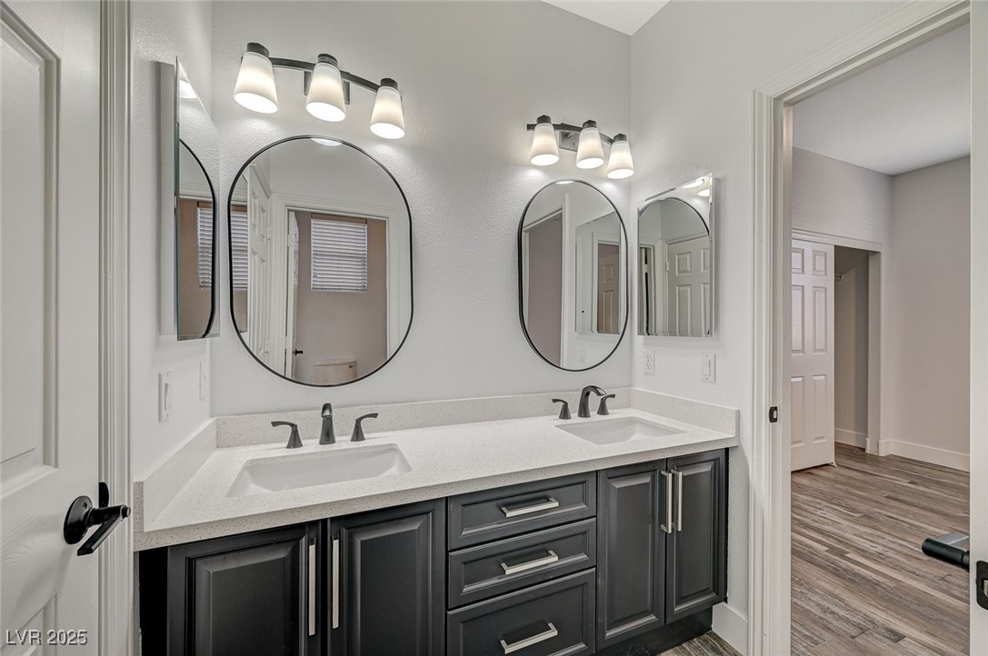 1335 Rolling Sunset Street Henderson, NV 89052 - Photo 15 of 72 Full bath with double vanity, wood finished floors