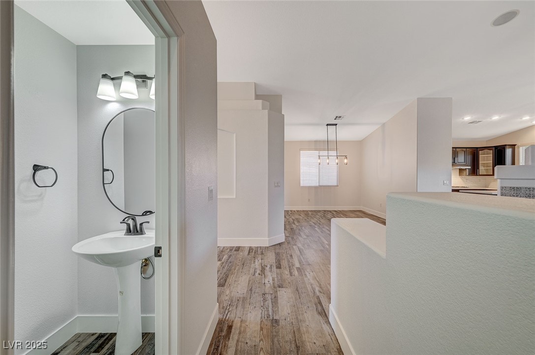 1335 Rolling Sunset Street Henderson, NV 89052 - Photo 16 of 72 Bathroom featuring baseboards, an inviting chandel