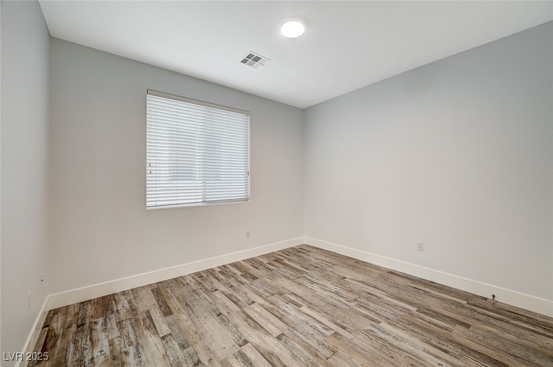 1335 Rolling Sunset Street Henderson, NV 89052 - Photo 35 of 72 Spare room featuring visible vents, baseboards, an
