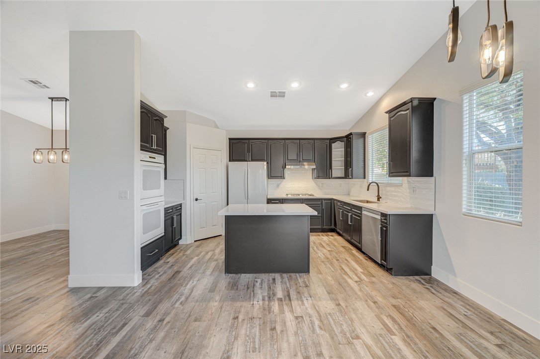 1335 Rolling Sunset Street Henderson, NV 89052 - Photo 40 of 72 Kitchen with visible vents, a center island, light