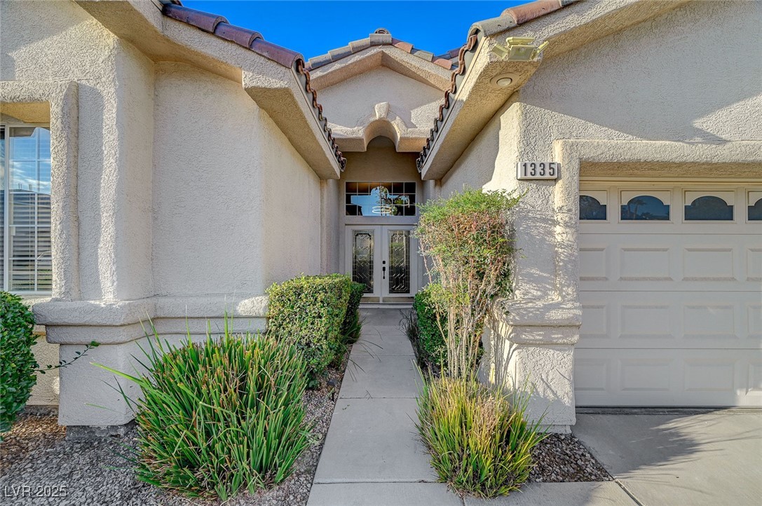 1335 Rolling Sunset Street Henderson, NV 89052 - Photo 5 of 72 Property entrance with a tiled roof, stucco siding