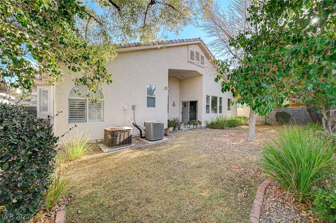 1335 Rolling Sunset Street Henderson, NV 89052 - Photo 56 of 72 Rear view of property featuring stucco siding, a y