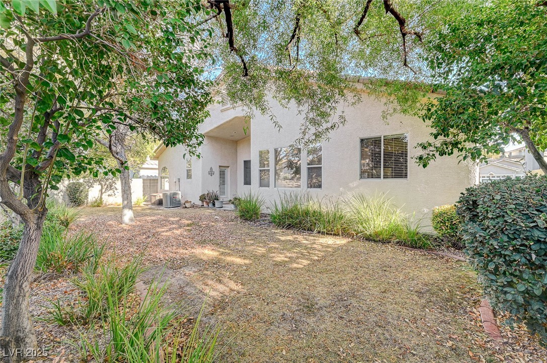 1335 Rolling Sunset Street Henderson, NV 89052 - Photo 57 of 72 Back of house featuring stucco siding, central AC,
