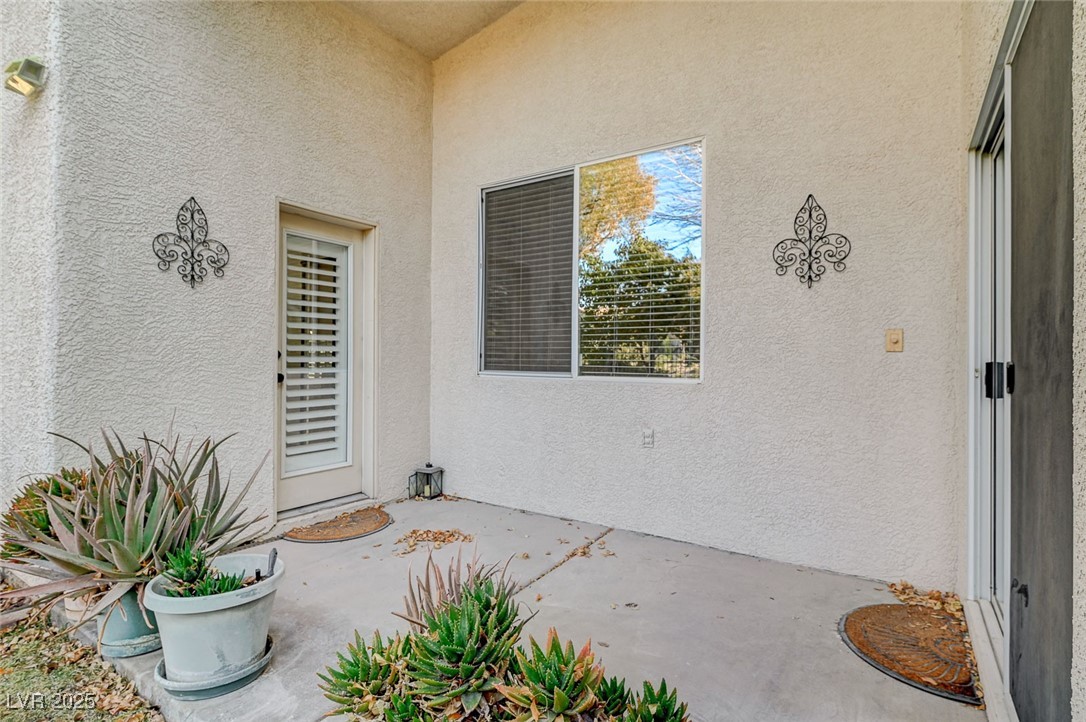 1335 Rolling Sunset Street Henderson, NV 89052 - Photo 61 of 72 Entrance to property featuring a patio and stucco