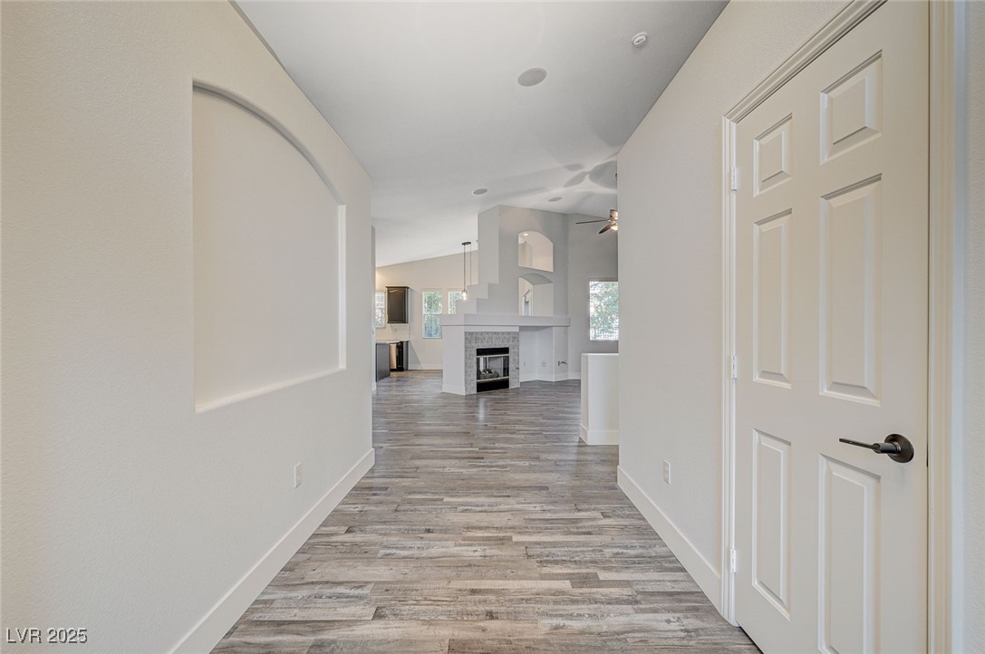 1335 Rolling Sunset Street Henderson, NV 89052 - Photo 7 of 72 Hall featuring baseboards, lofted ceiling, and lig