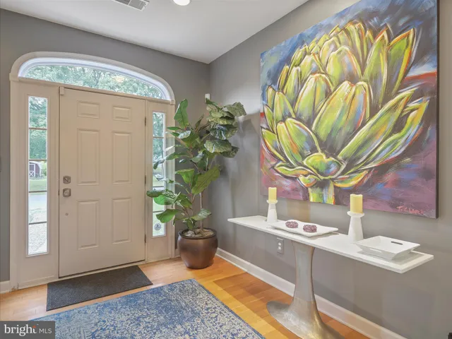 a view of bathroom with a sink a mirror and a potted plant