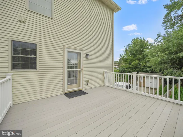 a view of a house with wooden deck