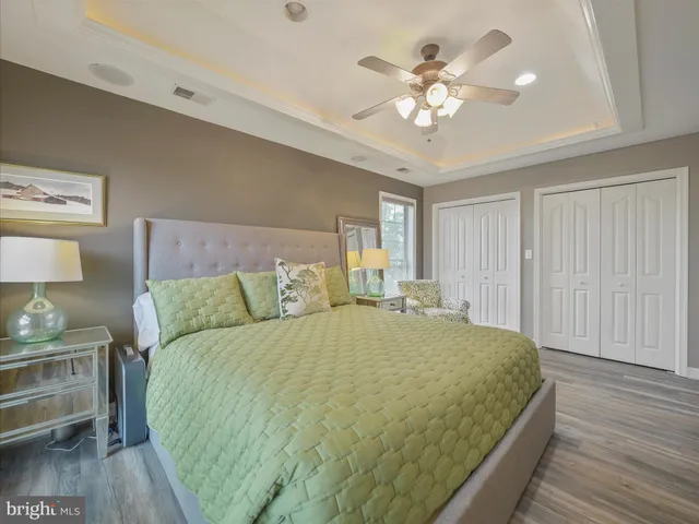 a bedroom with a large bed a chandelier and closet