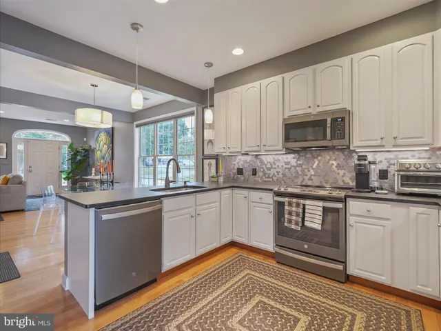 a kitchen with granite countertop a sink and cabinets