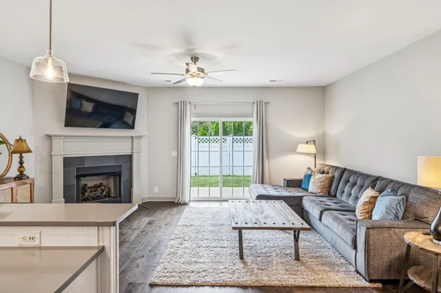 a living room with furniture a flat screen tv and a fireplace
