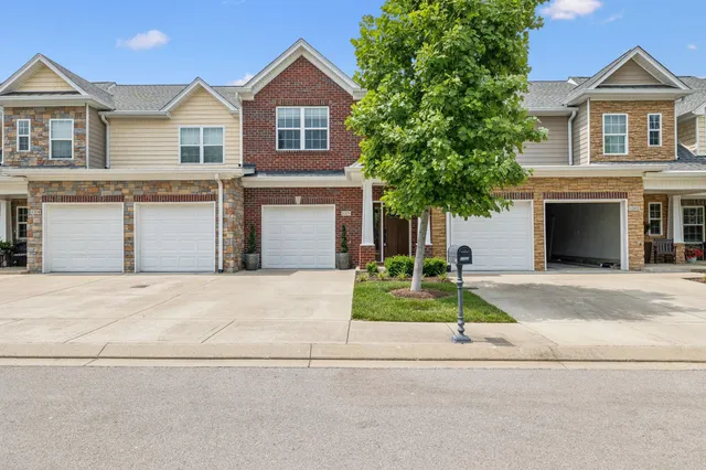 a front view of a house with a yard and garage