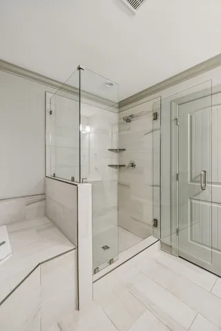 a bathroom with a shower and a sink a mirror