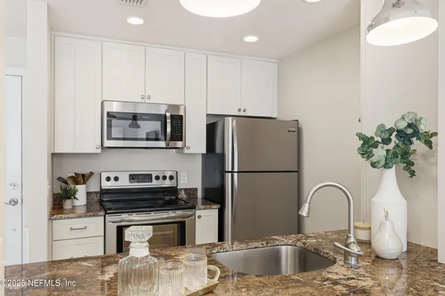 a dining room with furniture a rug and wooden floor