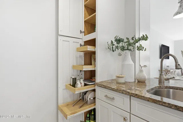 a living room with furniture a large window and a flat screen tv