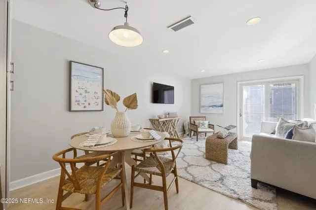 a living room with furniture kitchen view and a table
