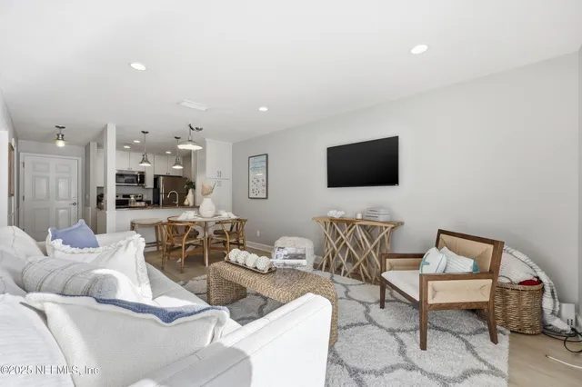 a living room with furniture a ceiling fan and a window