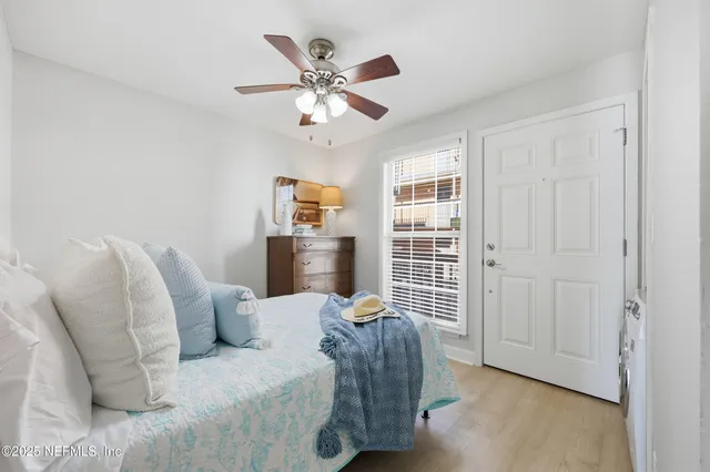 a bedroom with a large bed and a large window