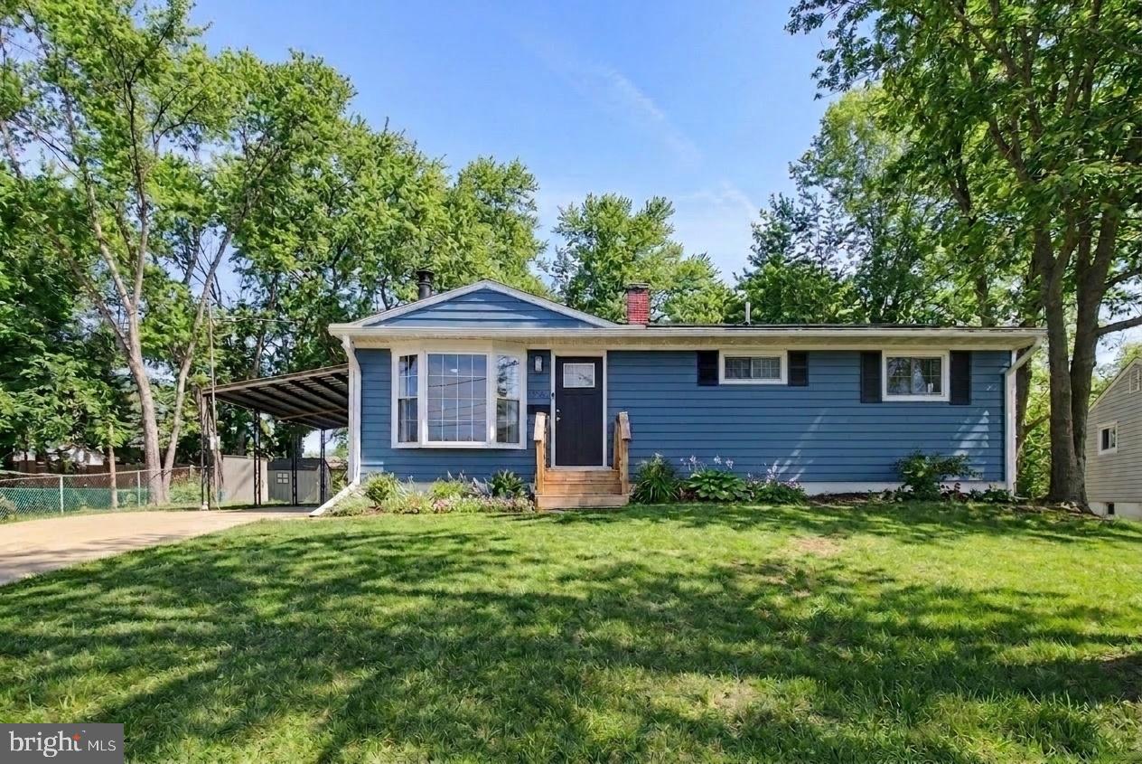 Charming blue home with lush greenery.