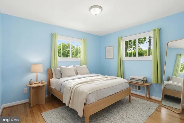 a bedroom with a bed and a lamp