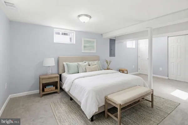 a bedroom with a bed and a chair