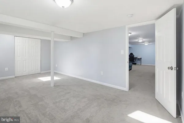 a view of an empty room and closet area