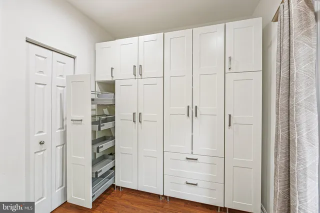 a spacious bathroom with a granite countertop sink a mirror and shower