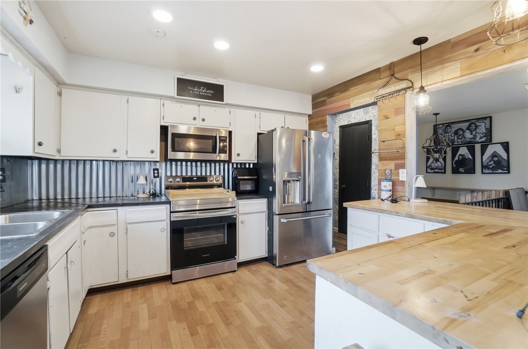 290 Ginghamsburg Road Tipp City, OH 45371 - Photo 16 of 49 This kitchen blends rustic charm with practical, modern amenities, creating an inviting space for everyday living.