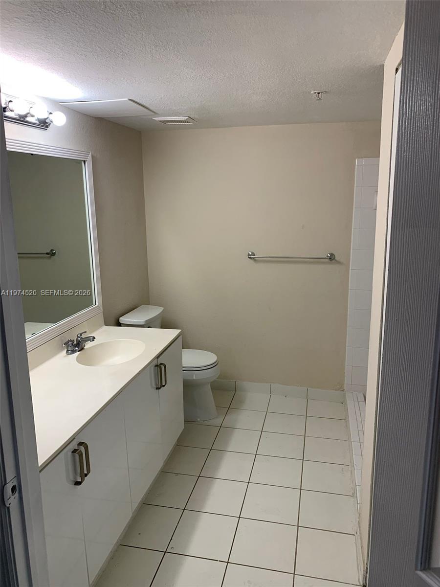 15440 Southwest 284th Street, Unit 5102 Homestead, FL 33033 - Photo 15 of 27 a bathroom with a sink a toilet and mirror