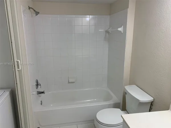a bathroom with a toilet and a bath tub