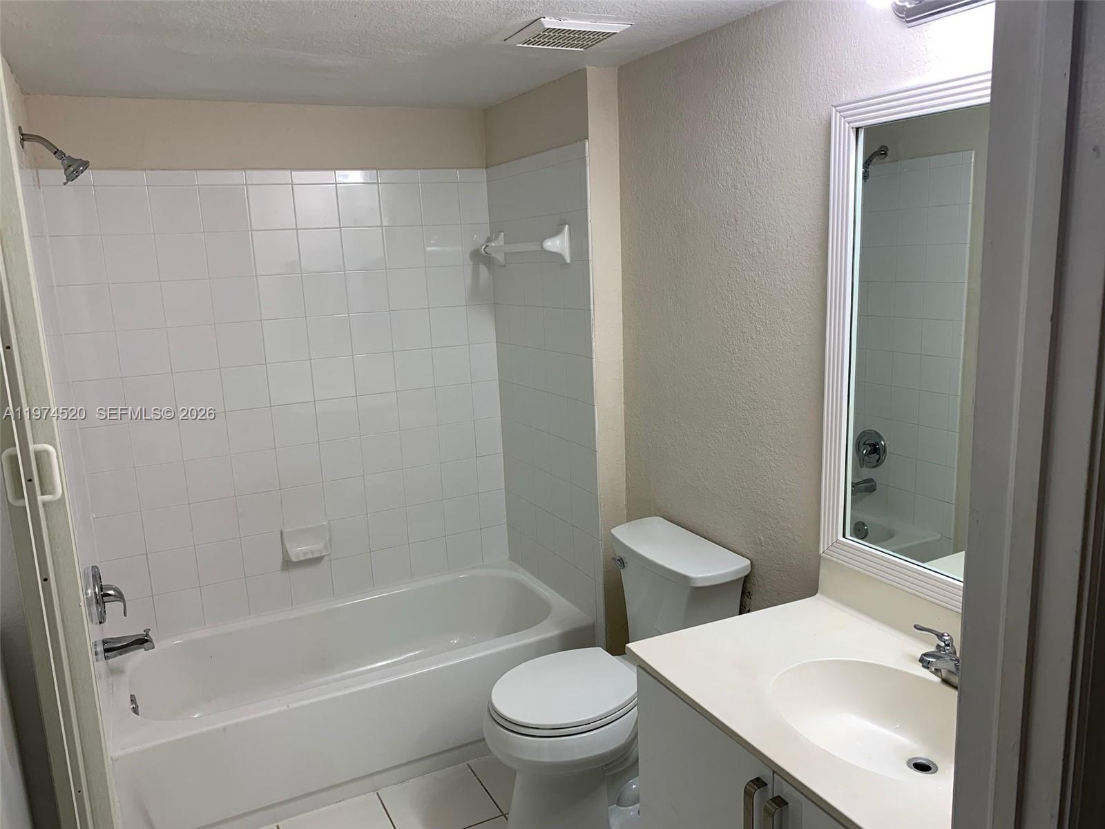 15440 Southwest 284th Street, Unit 5102 Homestead, FL 33033 - Photo 26 of 27 a white toilet sitting next to a bath tub