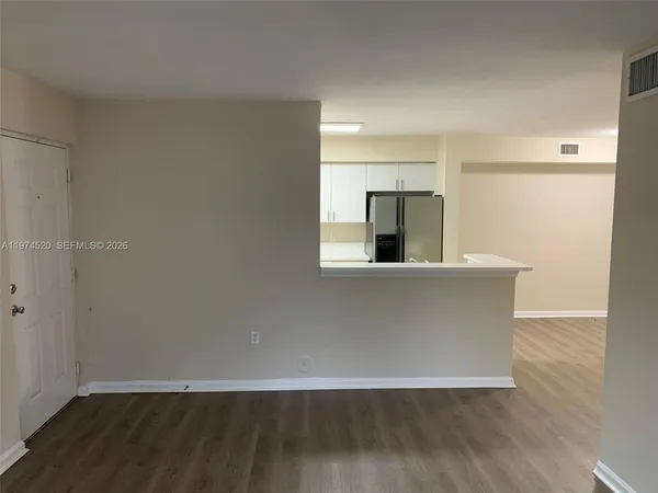 a view of a kitchen with wooden floor