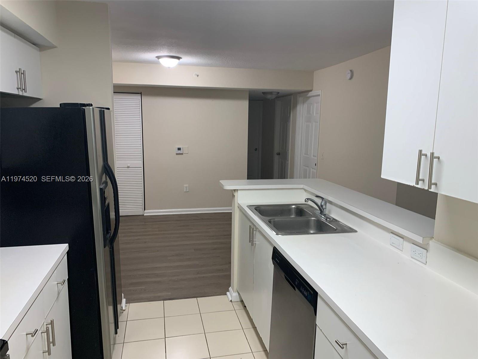 15440 Southwest 284th Street, Unit 5102 Homestead, FL 33033 - Photo 5 of 27 a kitchen with a sink a stove and a refrigerator