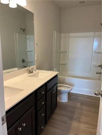 a bathroom with a sink a toilet and mirror