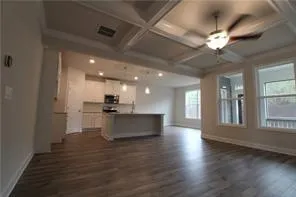 a view of a kitchen with sink and wooden floor