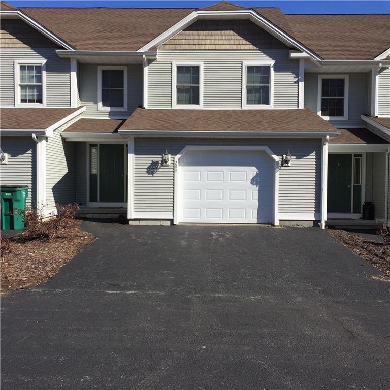 707 Chestnut Hill Road, Unit 204 Killingly, CT 06241 - Photo 1 of 1 a front view of a house with a yard and garage
