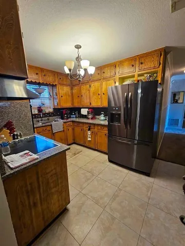 a kitchen with stainless steel appliances granite countertop a sink and cabinets