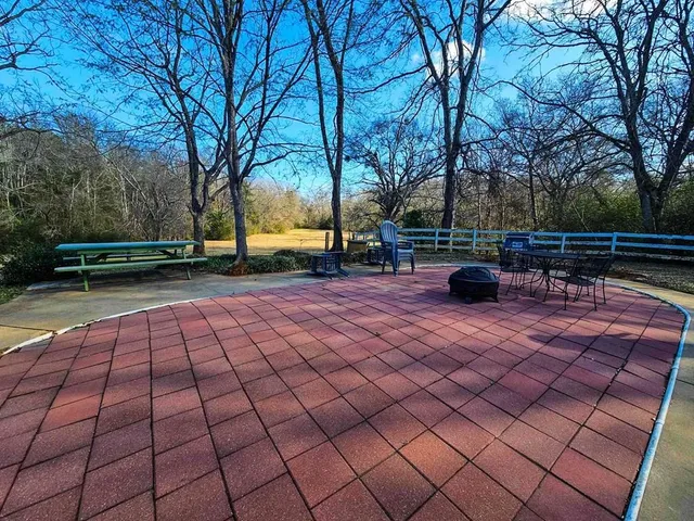 a view of a house with a yard and sitting area