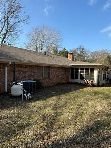 a view of a yard with a house in the background