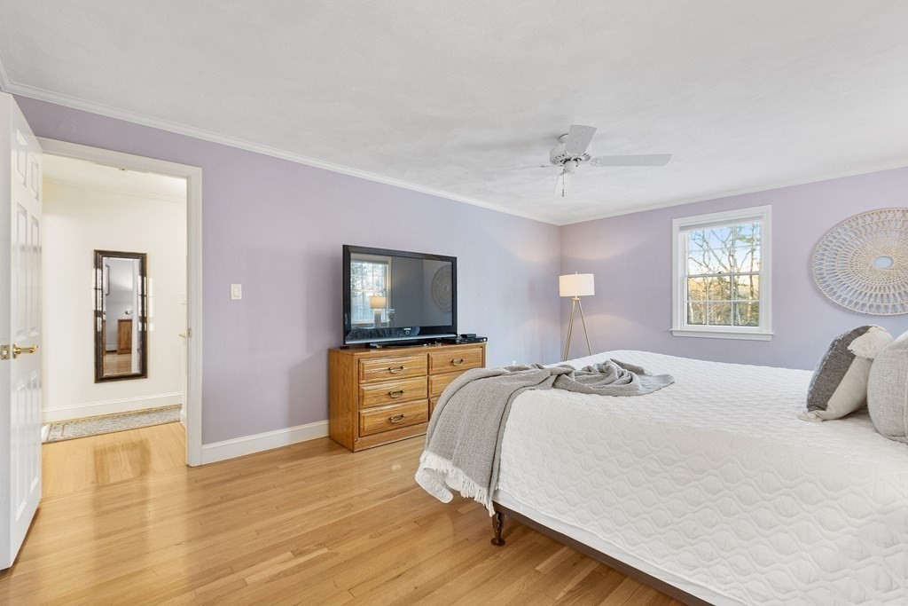 420 Old Harvard Road Boxborough, MA 01719 - Photo 25 of 37 a bedroom with a bed and wooden floor