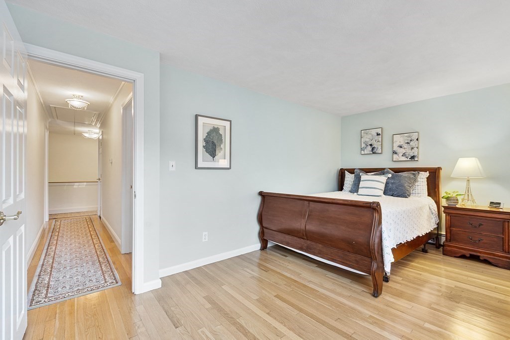 420 Old Harvard Road Boxborough, MA 01719 - Photo 29 of 37 a spacious bedroom with a bed and a wooden floor