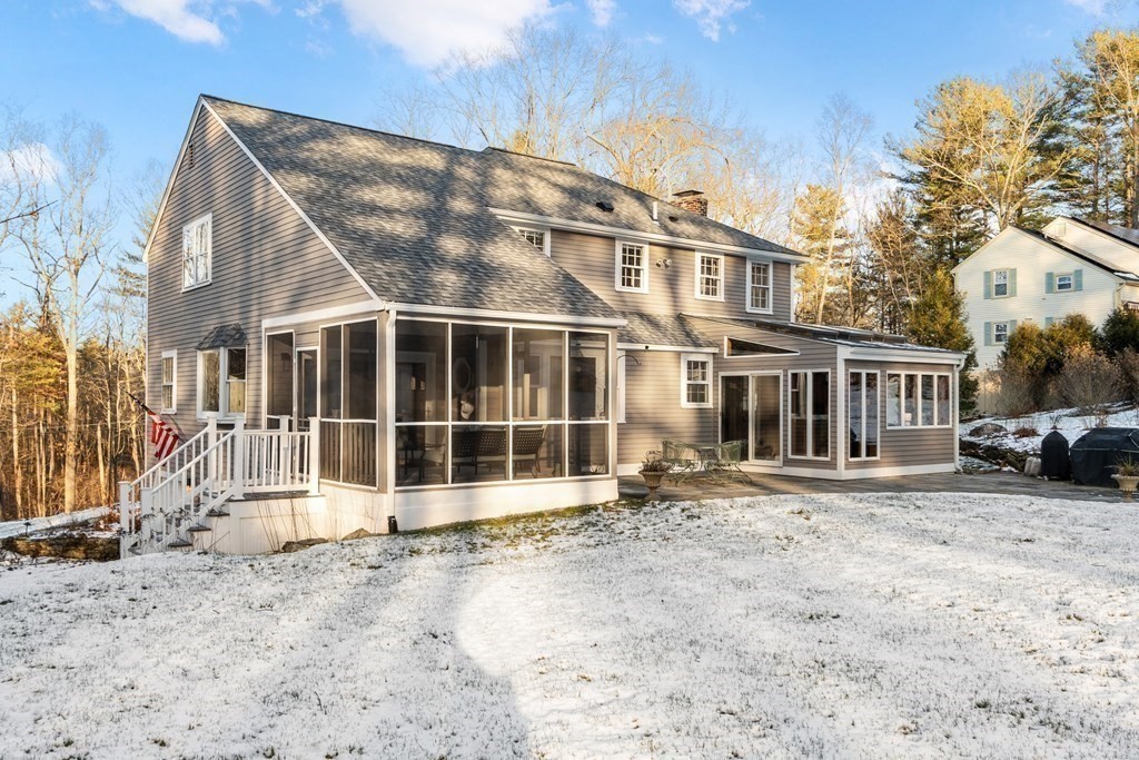 420 Old Harvard Road Boxborough, MA 01719 - Photo 31 of 37 a view of a blue house with a large window and a yard